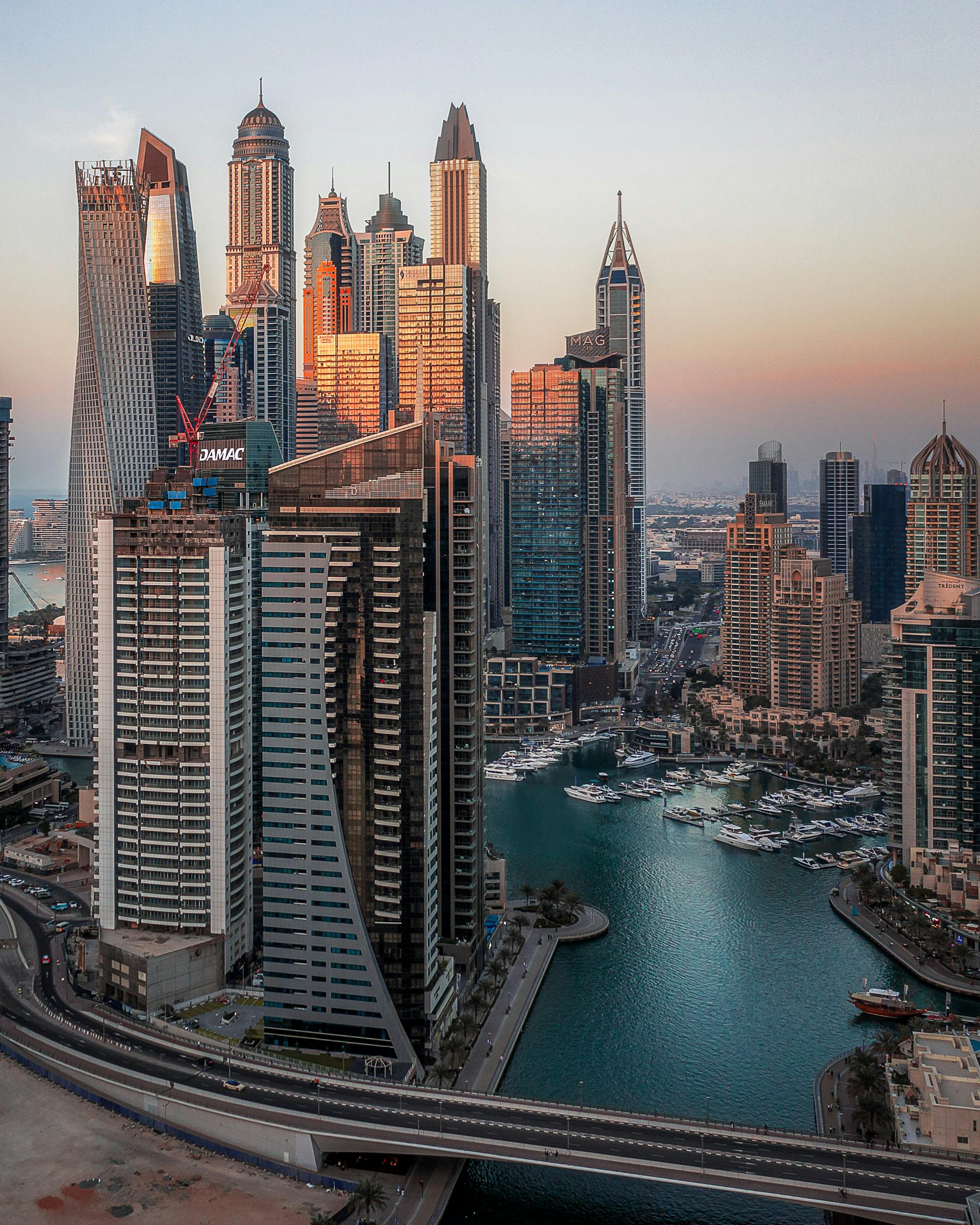 Captivating aerial photograph of Dubai Marina highlighting its iconic skyscrapers during sunset.